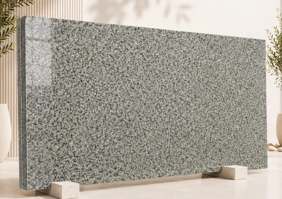 Apple Green granite: a sage green-grey polished surface with a dense speckled grain of dark and light minerals