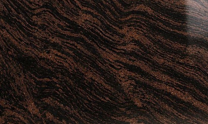 Himalyan Brown granite: banded copper, rust and black stripes flowing diagonally across a polished slab
