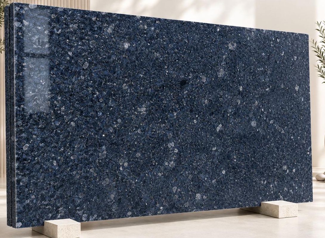Ice Blue granite: a deep marine-blue polished surface scattered with pale crystal flecks of feldspar