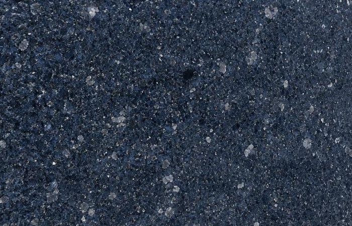 Ice Blue granite: a deep marine-blue polished surface scattered with pale crystal flecks of feldspar