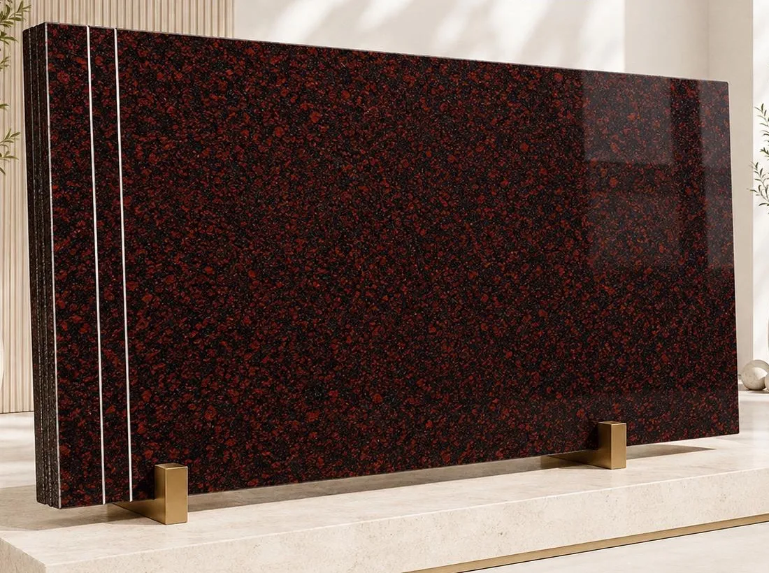 Kondakattu Red granite: rounded oxblood-red crystals set in a near-black polished ground, with deep lacquer-like reflections