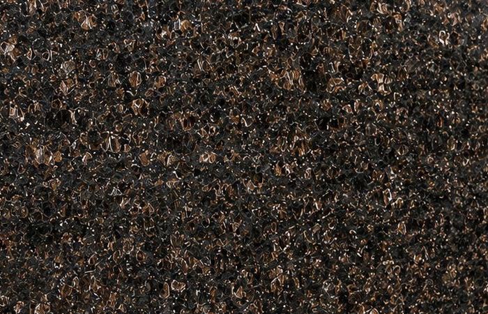 Tan Brown granite: rounded tan-brown crystals set in a near-black polished ground