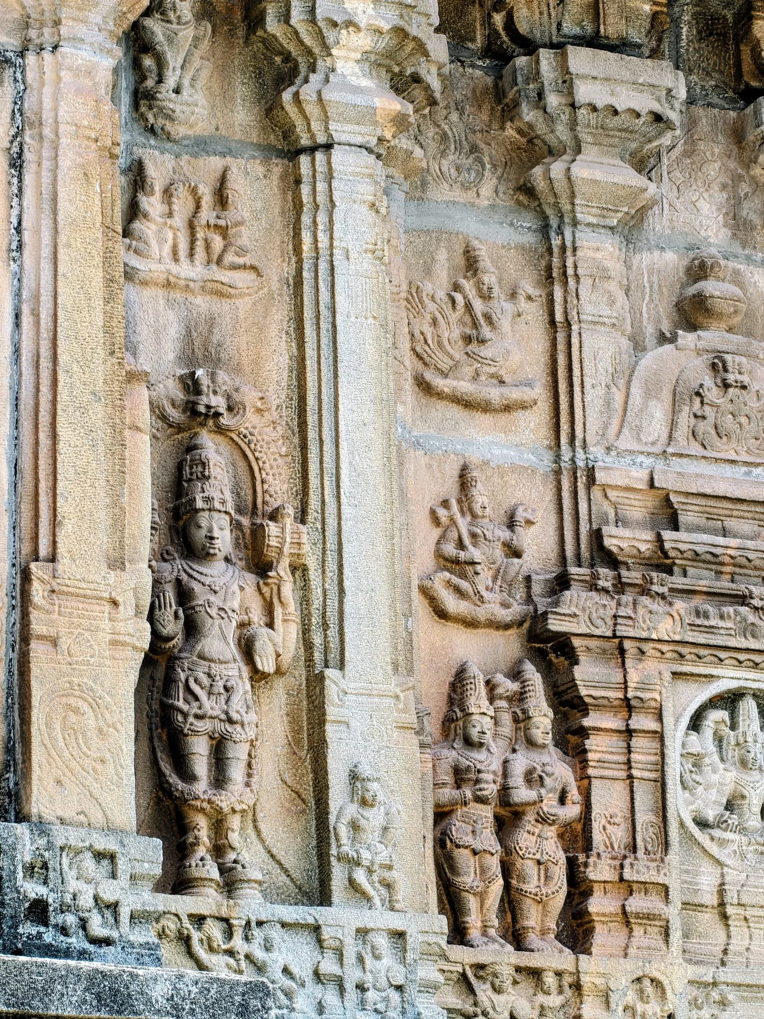 Deeply carved granite deities on a South Indian temple façade