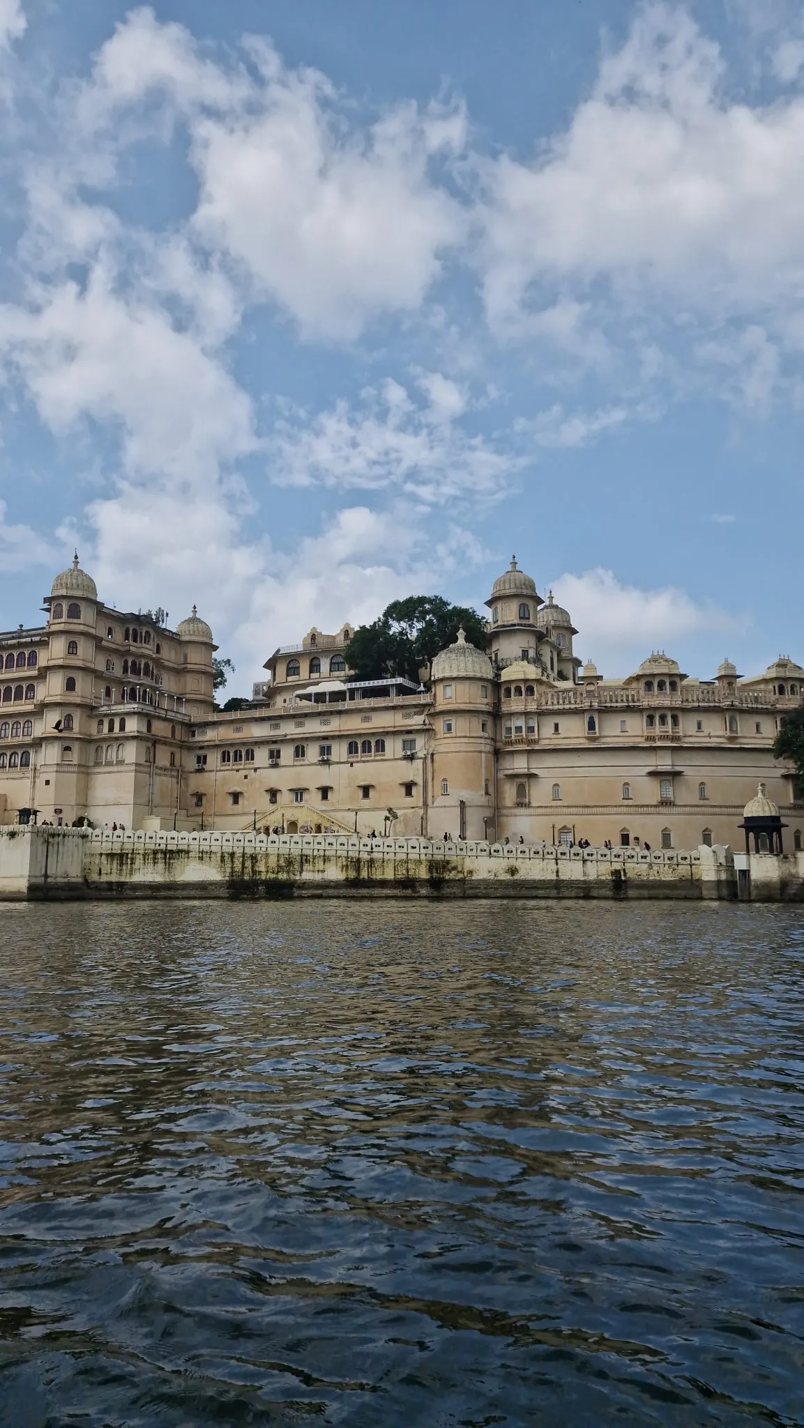 City Palace, Udaipur, rising above Lake Pichola — Rajasthani stone architecture